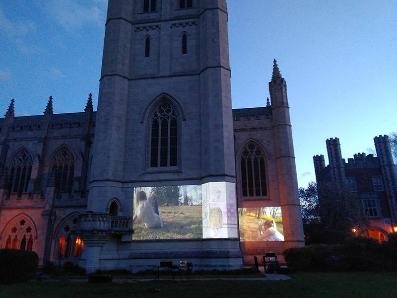 a film projected onto the side of the Trinity College chapel